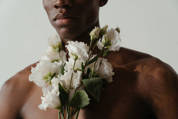 Man posing with white flowers for spring | OneNightOnly