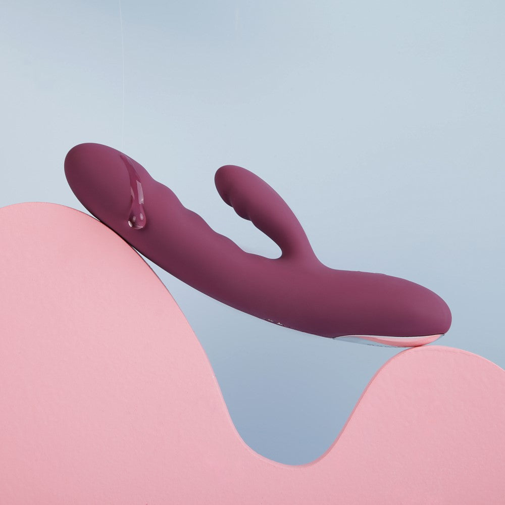 Side View Of Avery Thrusting Rabbit Vibrator | Svakom - Lilac Dripping With Lube Lifestyle Style On Blue Background
