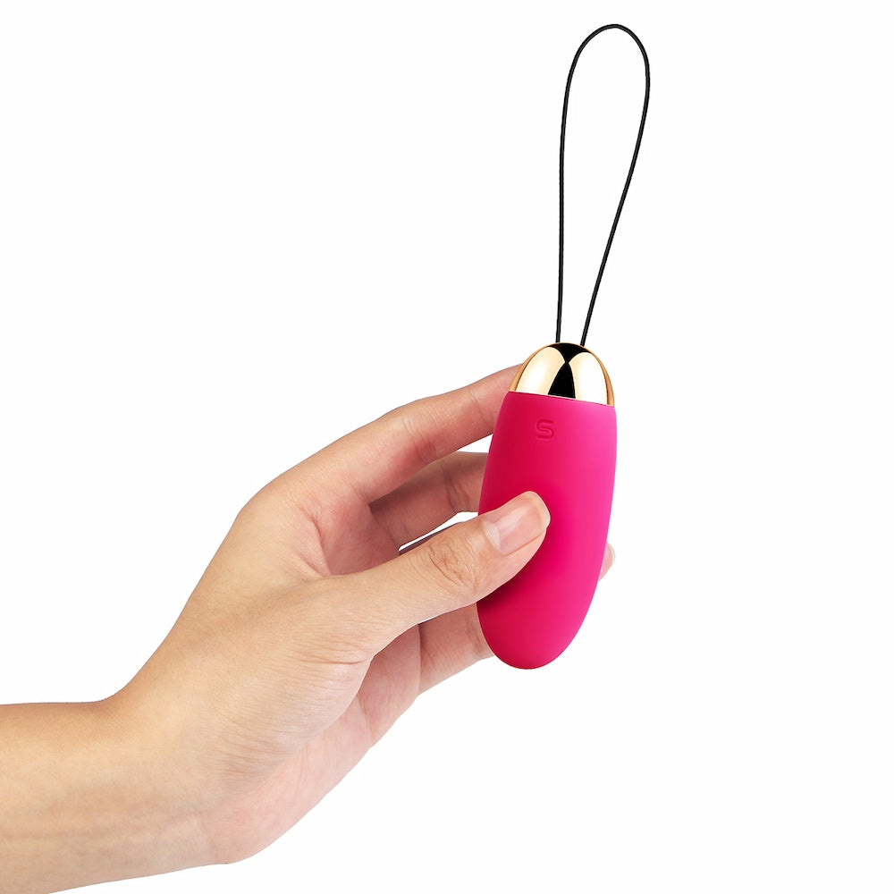 Hand Holding Elva Remote-Controlled Vibrating Bullet Egg | Svakom - Plum Red On White Background
