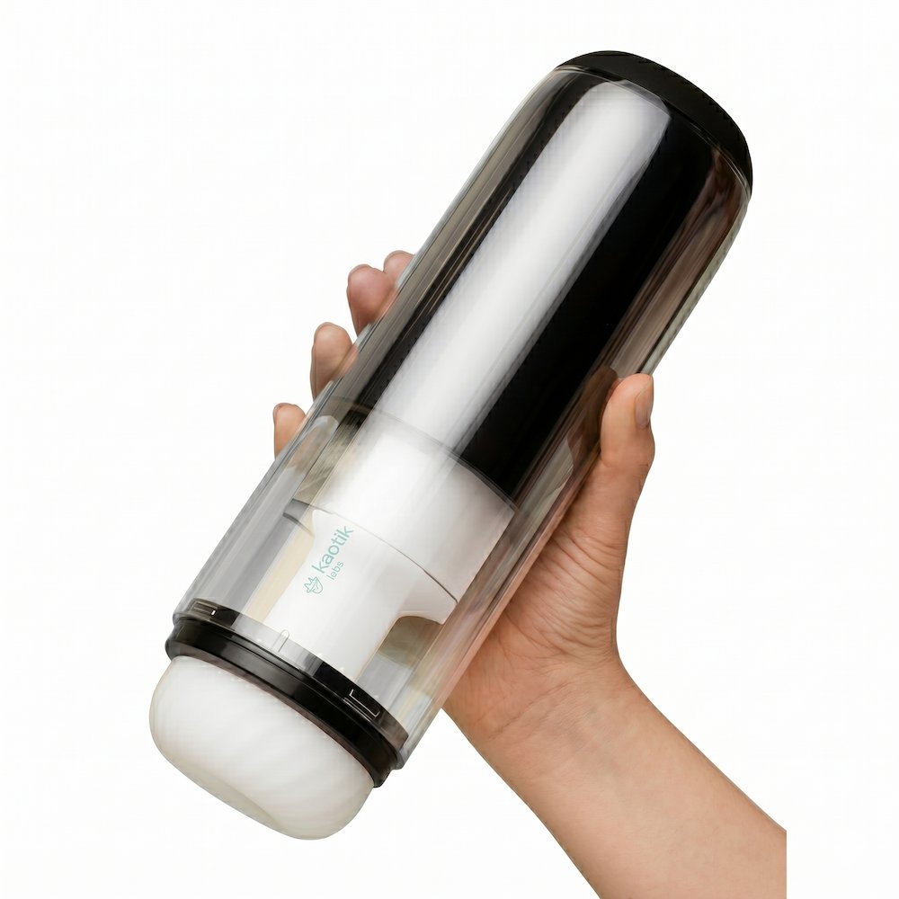 Kaotik Labs The Cocoon Interactive Vibrating, Throbbing & Warming Masturbator held in one hand to show the product size and transparent casing.