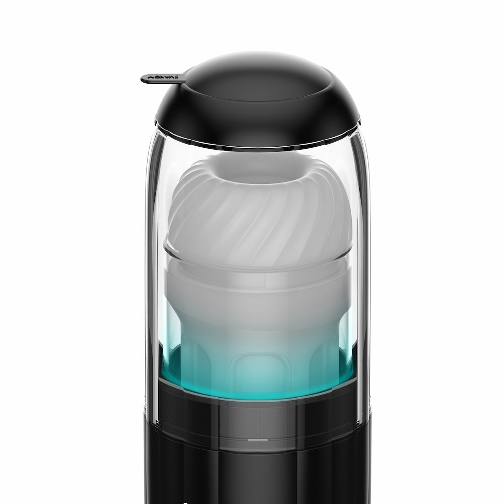 Close-up top view of Kaotik Labs The Shockwave Interactive Powerful Thrusting Masturbator showing the black rim, pull tab and white textured sleeve under the transparent cover.
