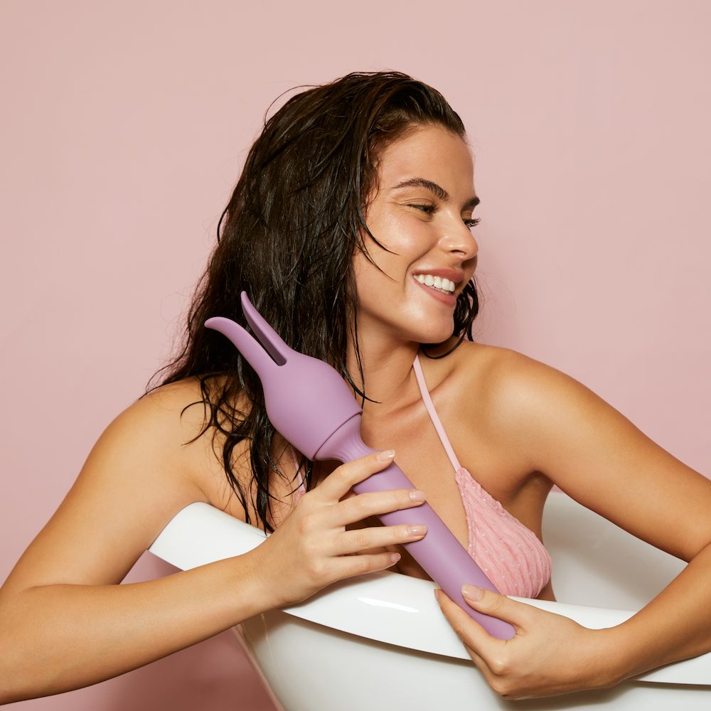 Woman In Bath Tub Holding Svakom Emma Neo 2 Interactive Warming Wand Vibrator With Bunny Ear Attachment