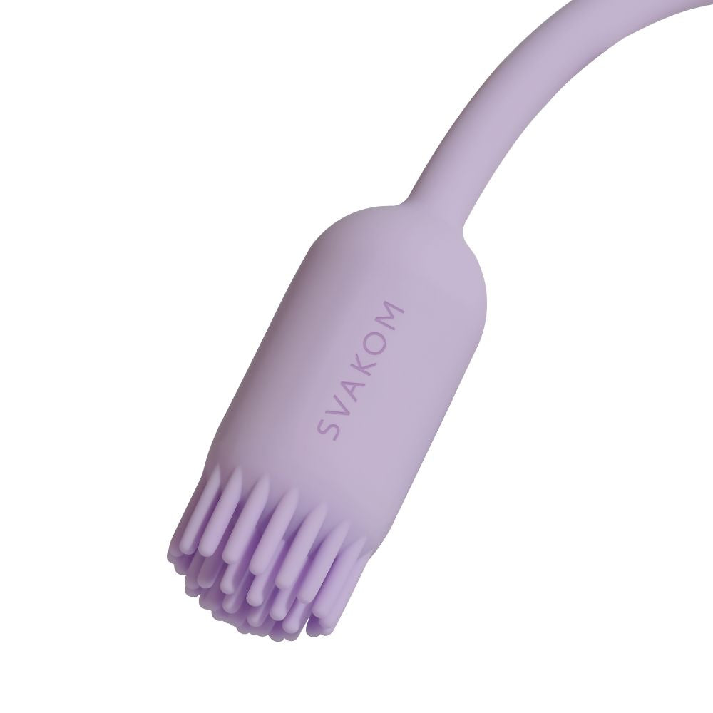 Close-up of the brush-tip end of Svakom Plume Interactive Brush Tail Bullet Vibrator in pastel lilac, showing the soft silicone brush texture and Svakom branding.