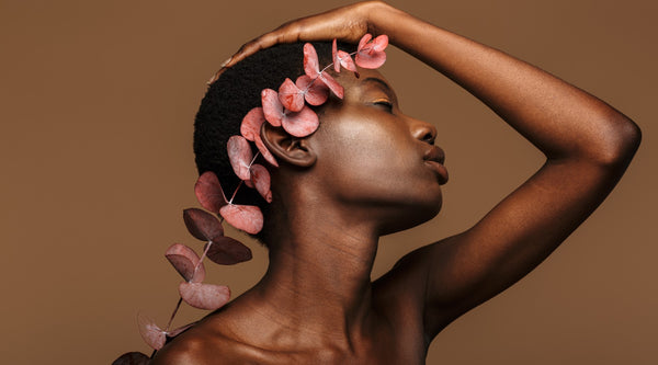 Woman Posing Sensually With A Flower Behind Her Ear For Spring | OneNightOnly