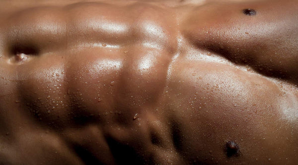 Closeup of male model's sweaty abs