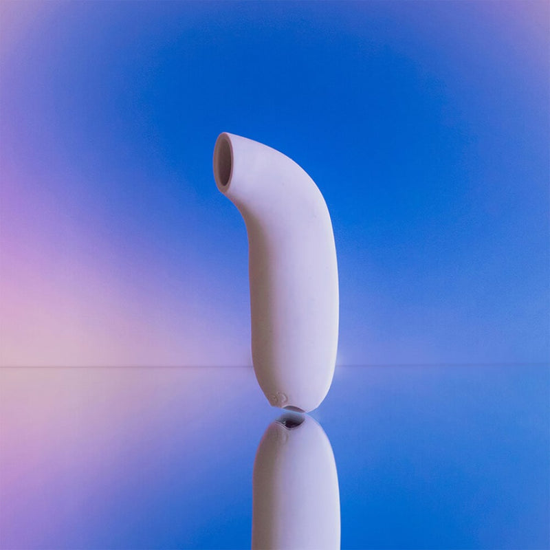 Dame | Aer Clitoral Suction Toy displayed on mirrored surface
