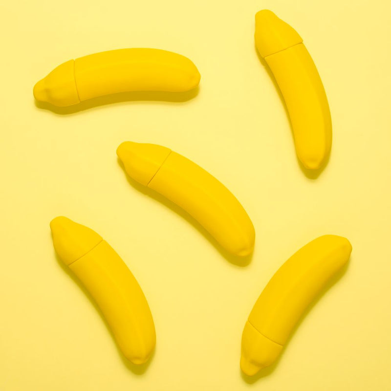 Bunch of Emojibator | The Official Banana Emoji Vibrator's on yellow background