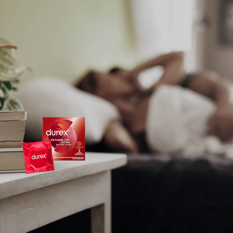 Fetherlite Ultra Condoms | Durex (3s) on bedsite table