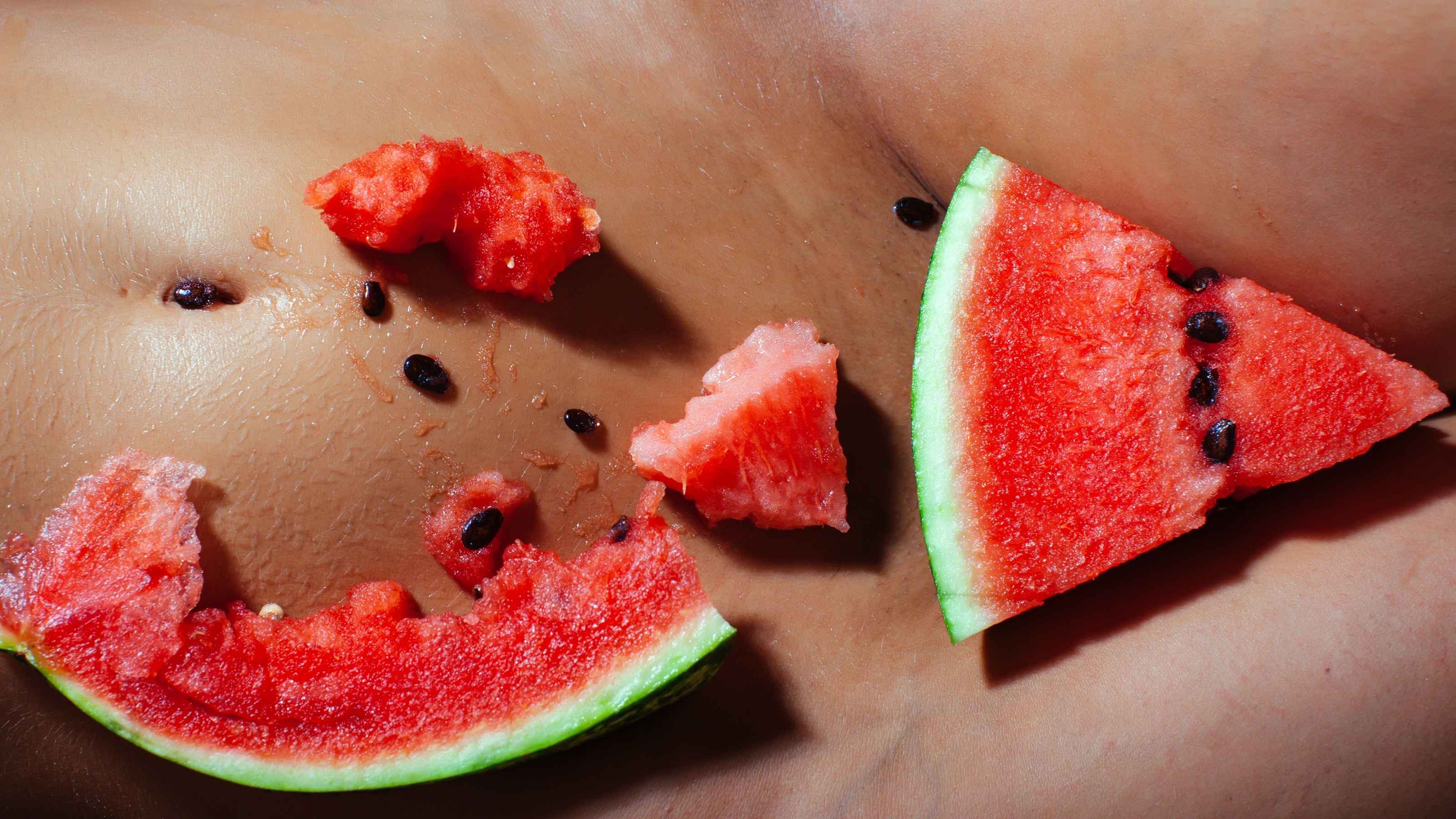 Slices of watermelon on a woman's skin for OneNightOnly