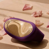 Lelo | Sona 2 Travel Sonic Clitoral Massager (Purple) lying on a table with rose petals
