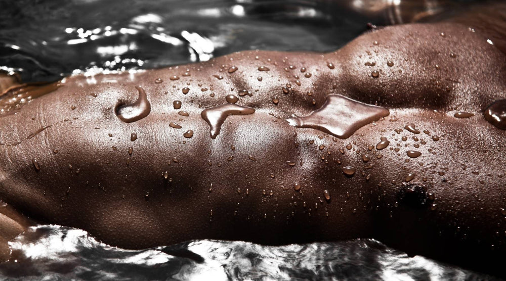 Topless Male Model With Abs Lying In Water | OneNightOnly