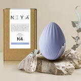 N4 Palm Massager | Niya on rocks with packaging behind
