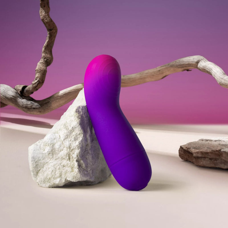 Rocks-Off Glow Girl Vibe Discreet G-Spot Vibrator leaning on a rock