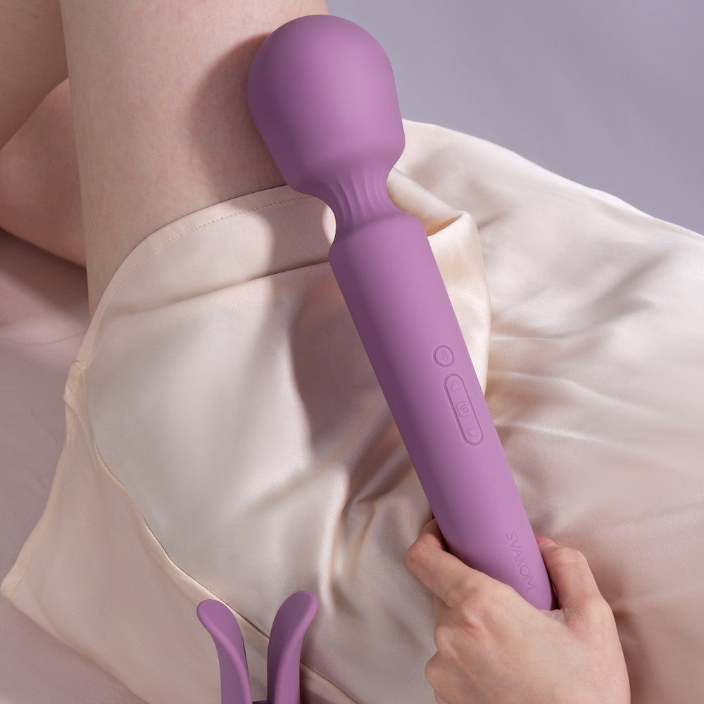 Hand Holding Svakom Emma Neo 2 Interactive Warming Wand Vibrator On Leg 