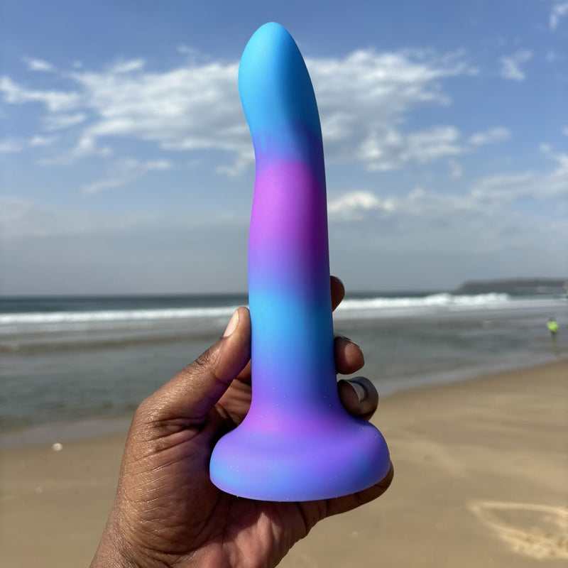 Swan Addiction | Rave 8 Inch Glow-In-The-Dark Suction Cup Dildo on a beach