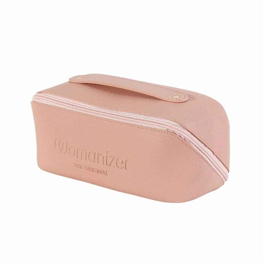 Blush pink Womanizer Cosmetic Toy Bag with Zip & Carry Handle, featuring the embossed 'Womanizer' logo on the front, set against a plain white background