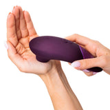 Womanizer | Next 3D Pleasure Air Clitoral Stimulator with Climax Control (Dark Purple) in hands