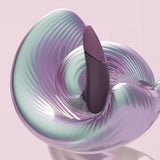 Womanizer | Next 3D Pleasure Air Clitoral Stimulator with Climax Control (Dark Purple) with an iridescent swirl background