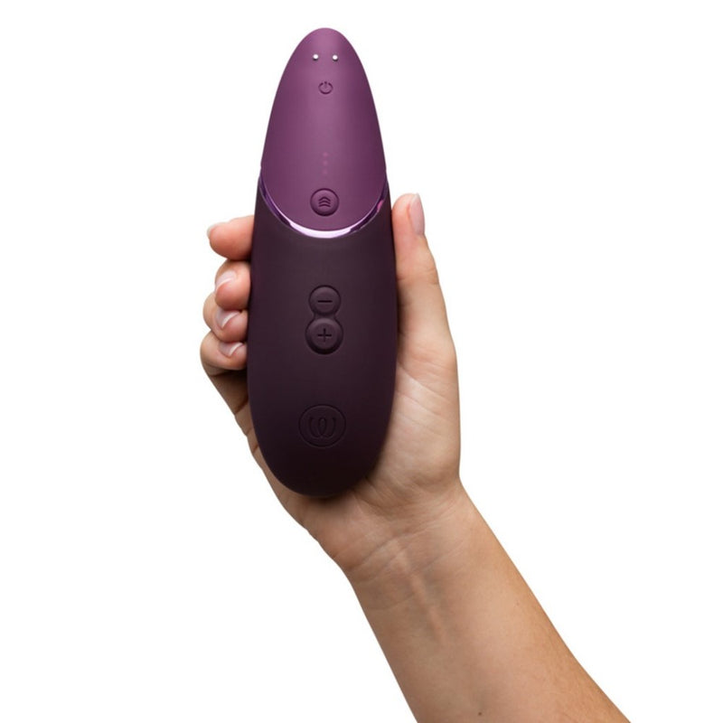 Womanizer | Next 3D Pleasure Air Clitoral Stimulator with Climax Control (Dark Purple) in hand