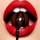 Woman with chocolate ball in her mouth for Chocolate Body Paint | Shunga