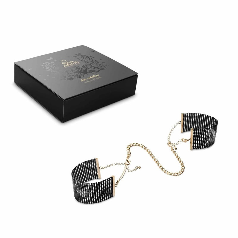 Full view of Désir Métallique Mesh Handcuffs | Bijoux Indiscrets- Black with product packaging 
