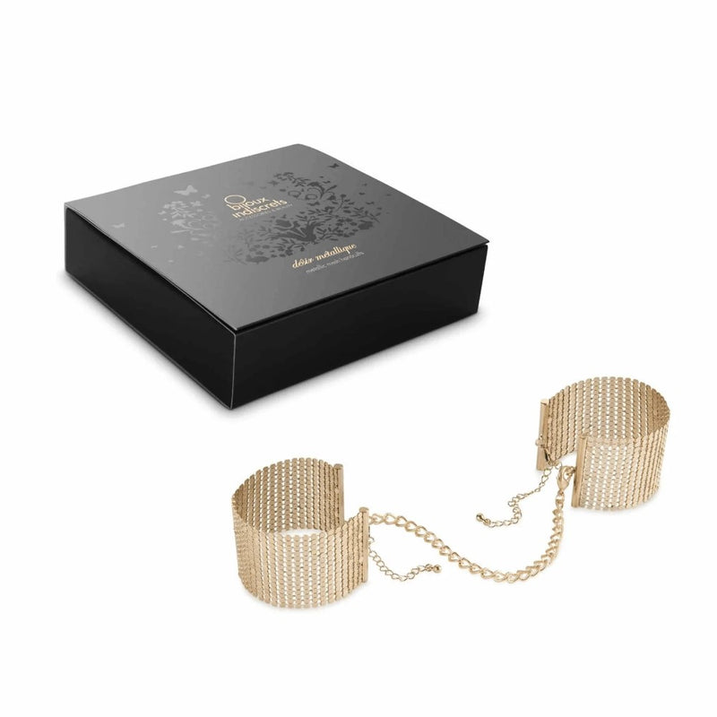 Full view of Désir Métallique Mesh Handcuffs | Bijoux Indiscrets - Gold with product packaging 
