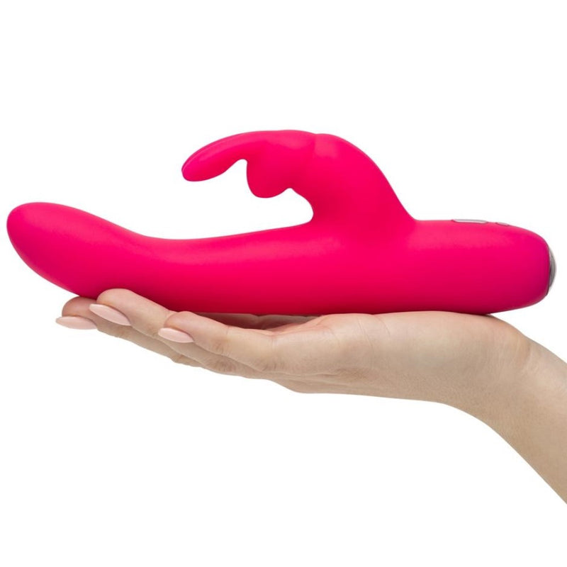 Flat lay view of Happy Rabbit Slimline Curve Vibrator | LoveHoney - Pink in hand 
