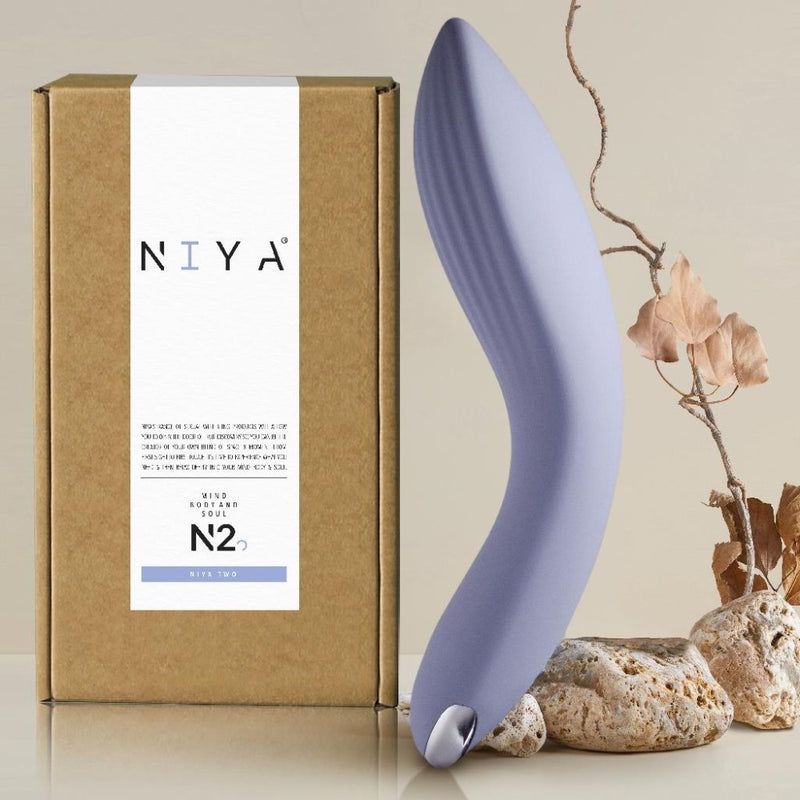 N2 Couples Massager | Niya with rocks and product packaging