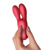Sugarboo | Coral Kiss Rabbit Ears Vibrator in hand 