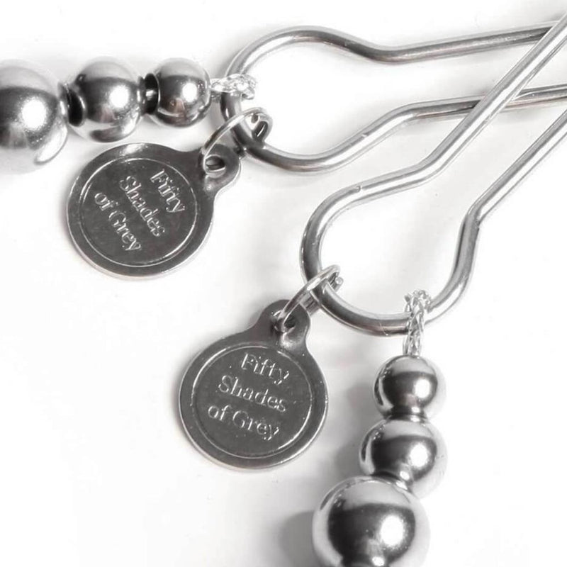 Engraved metal tags on The Pinch Adjustable Nipple Clamps by Fifty Shades